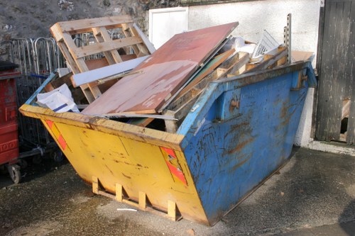Workers loading furniture into a small lorry during a Muswell Hill office clearance